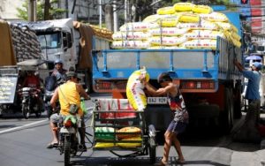 RICE. Workers unload sacks of rice at a warehouse in Tondo, Manila, on May 7, 2024. President Ferdinand R. Marcos Jr. has prioritized the amendments to the Rice Tariffication Law to bring down the price of rice in the retail market. (PNA photo by Yancy Lim)